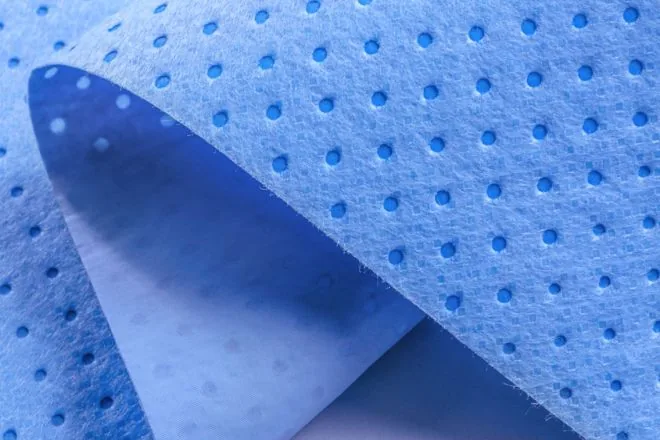 SMS composite nonwoven with polka dot embossing in blue
